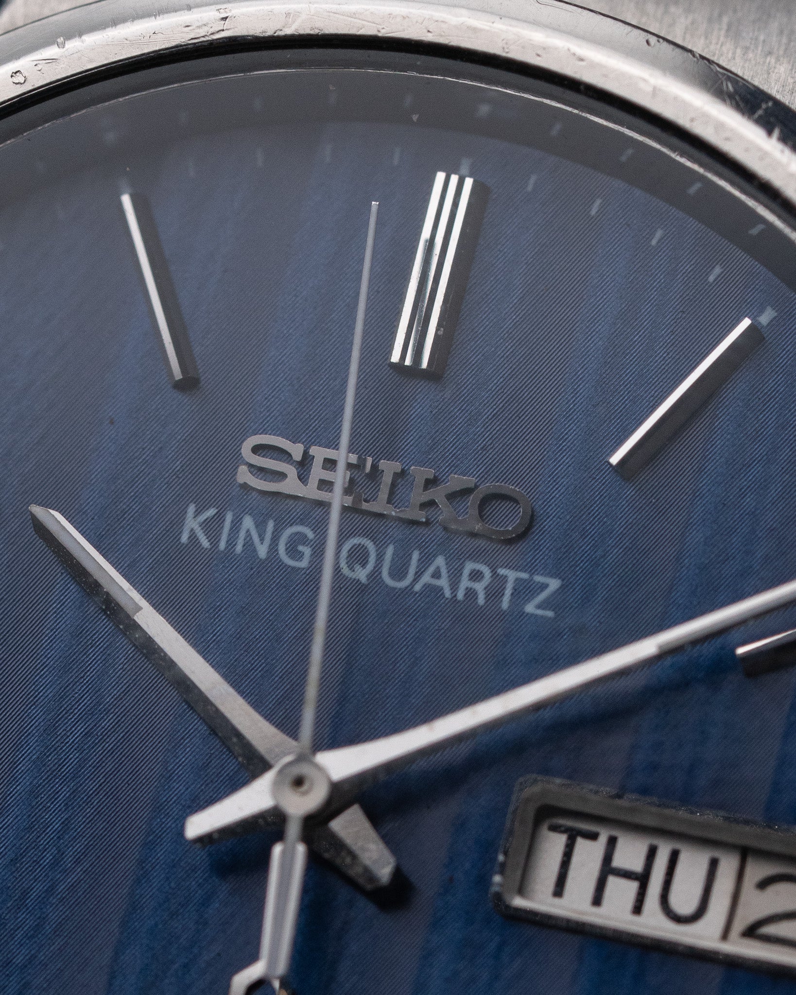 Close-up of a Seiko King Quartz watch with blue face and silver accents.