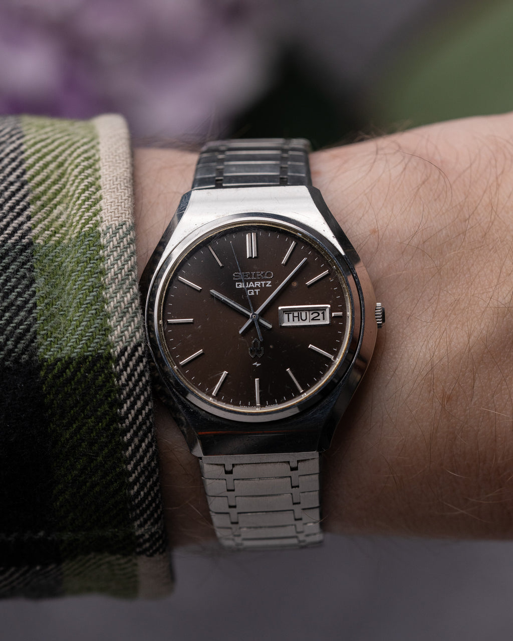 Seiko watch on a wrist with a blurred background